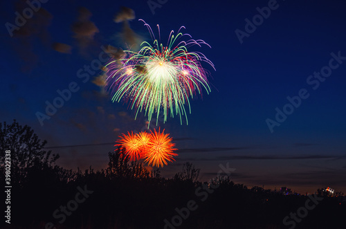 Brightly colorful firework in dark blue evening sky background