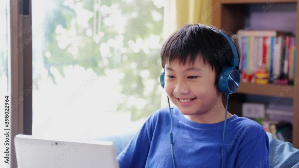 Asian boy student video call online learning class study video call zoom teacher online with laptop at home Asian boy student video call online learning class study video call zoom teacher online with laptop at home