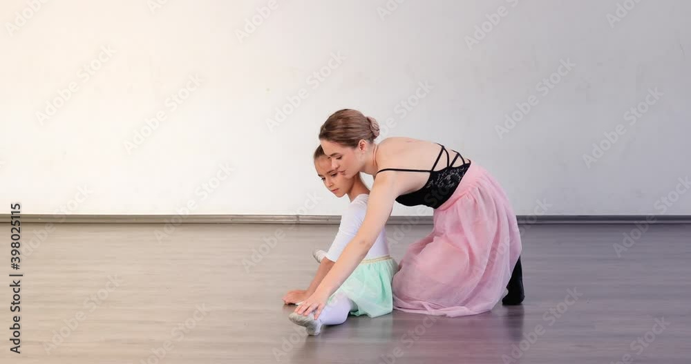 Little ballerina training with coach in dance studio Little ballerina training with coach in dance studio