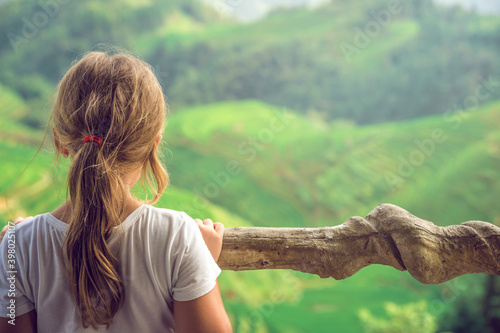 Cute young girl admiring Longji Rice Terraces photo