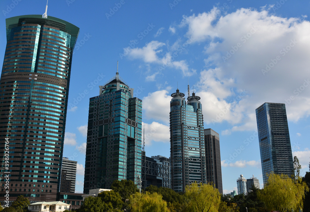 Fototapeta premium several green exterior buildings under blue sky in sunny afternoon 