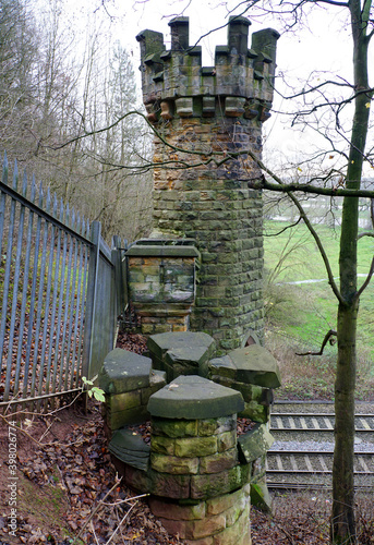 Castellated stone tower over a railway tunnel photo