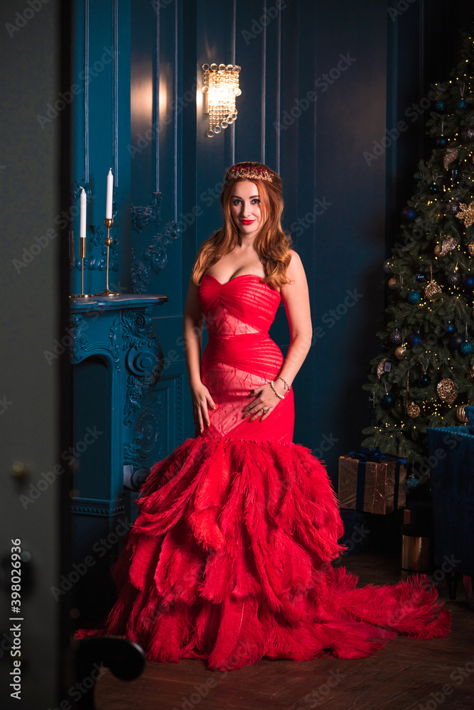 Christmas party, modern woman celebrate, lifestyle. Girl in luxury red dress with feathers, inspirations and New Year Christmas party, modern woman celebrate, lifestyle. Girl in luxury red dress with feathers, inspirations and New Year