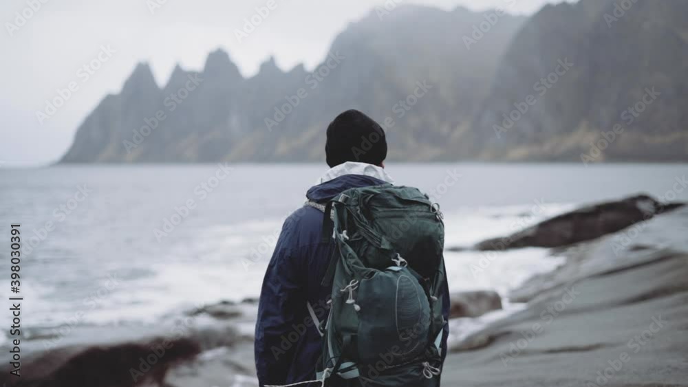 Hiker With Backpack Looking Over Fjord Hiker With Backpack Looking Over Fjord