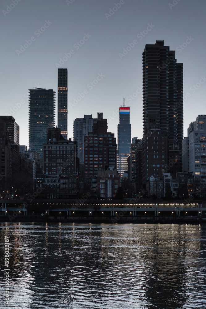 View of Manhattan skyline from the riverside at dusk