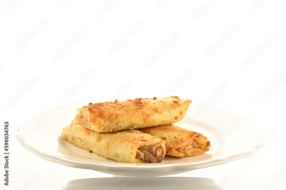 Several mini strudel with an apple, close-up, on a white background. Several mini strudel with an apple, close-up, on a white background.