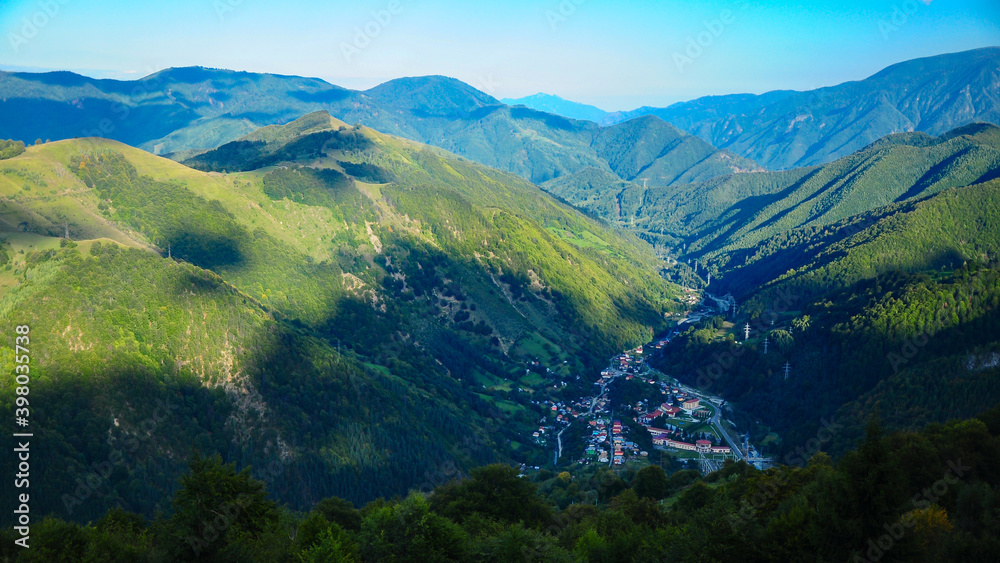 View from a mountain above Ciungetu village in a clear morning. Ciungetu is a town located along Latorita Valley, inside Latorita Mountains, surrounded by numerous wild forests. 