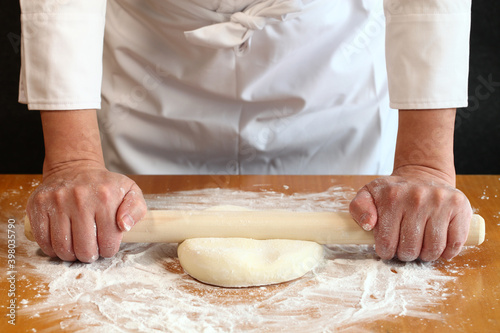 how to make japanese udon noodles; use a rolling pin to press a kneaded dough out