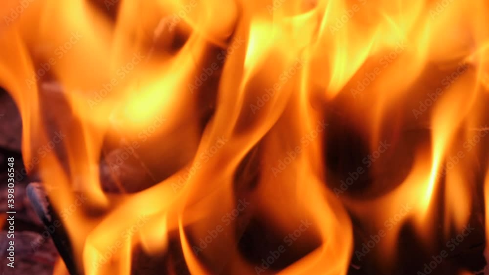 Fire flame in a fireplace, abstract dark background. Extreme closeup slow motion footage. Fire flame in a fireplace, abstract dark background. Extreme closeup slow motion footage.