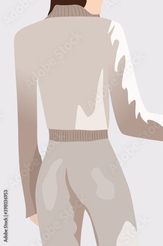 View from back of a brunette woman dressed in white sweater and pants