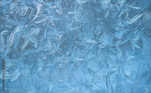  Frosty pattern on the window pane. Winter background