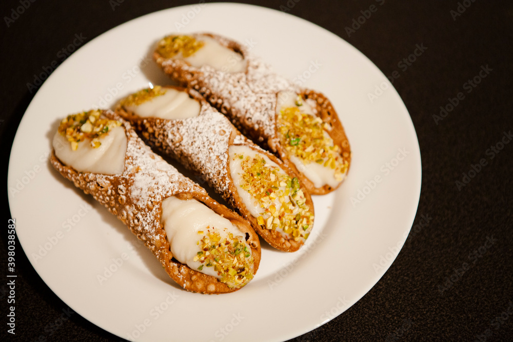 Cannoli are Italian pastries consisting of tube-shaped shells of fried pastry dough, filled with a sweet, creamy filling usually containing ricotta—a staple of Sicilian cuisine. Palermo, Sicily, Italy