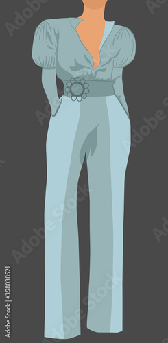 Woman dressed in light blue classic blouse, pants and belt posing with her ha...
