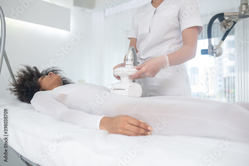 Dark haired girl in beauty center during procedure