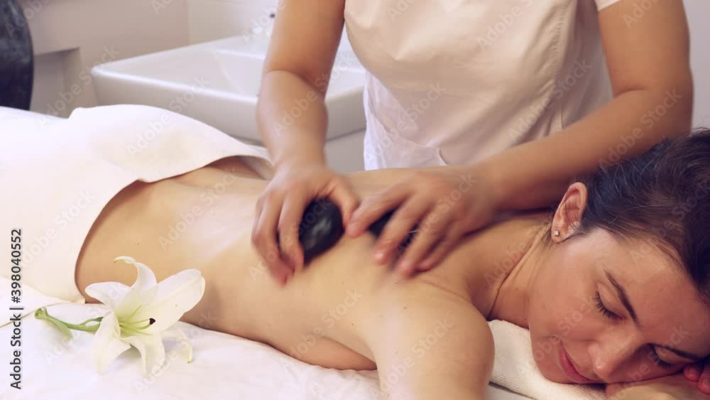 Young pretty woman relaxing in spa salon at hot stone body massage. Stone treatment and massage therapy. Zen and relax.
Young pretty woman relaxing in spa salon at hot stone body massage. Stone treatment and massage therapy. Zen and relax.