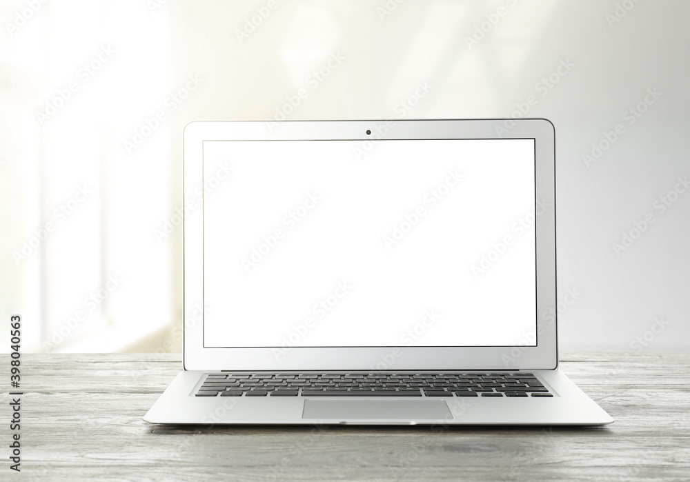 Modern laptop with blank screen on table indoors Modern laptop with blank screen on table indoors