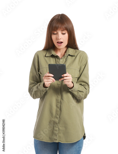 Surprised young woman with e-reader on white background © Pixel-Shot