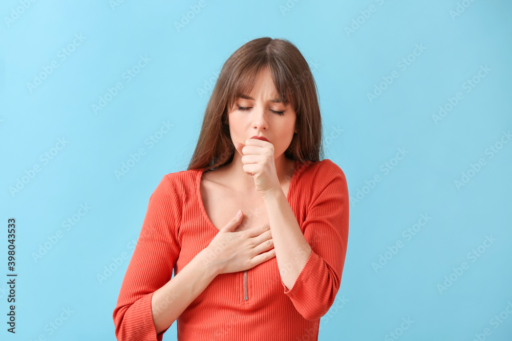 Coughing young woman on color background Coughing young woman on color background