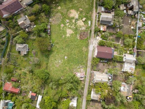 Aerial drone top view. A green meadow among the private sector. © Sergey