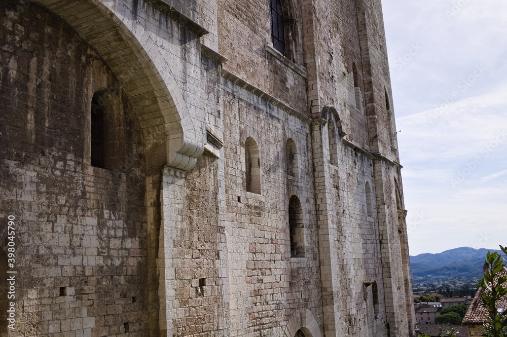 An old medieval stone building with windows and loopholes (Gubbio, Umbria, Italy)
