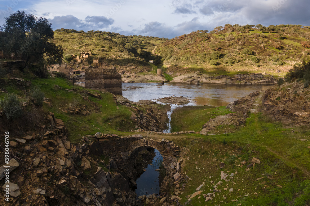 Bridge and other ancient ruins on the bank of the Alagon River.  Spain.