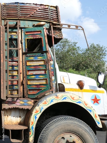 India - Maharashtra - Mumbai - Old colourful diesel truck on the streets of Mumbai in India. Painted wooden panels on the doors and roof carriers.
 photo