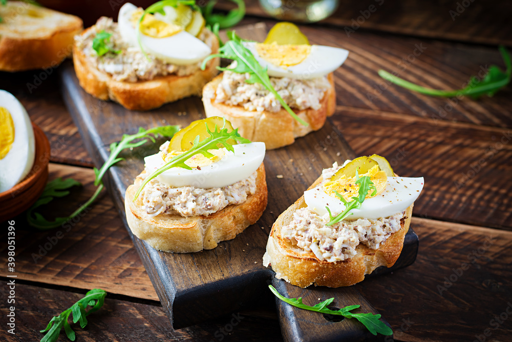 Toasted bread with a salted codfish mousse on wooden cutting board
