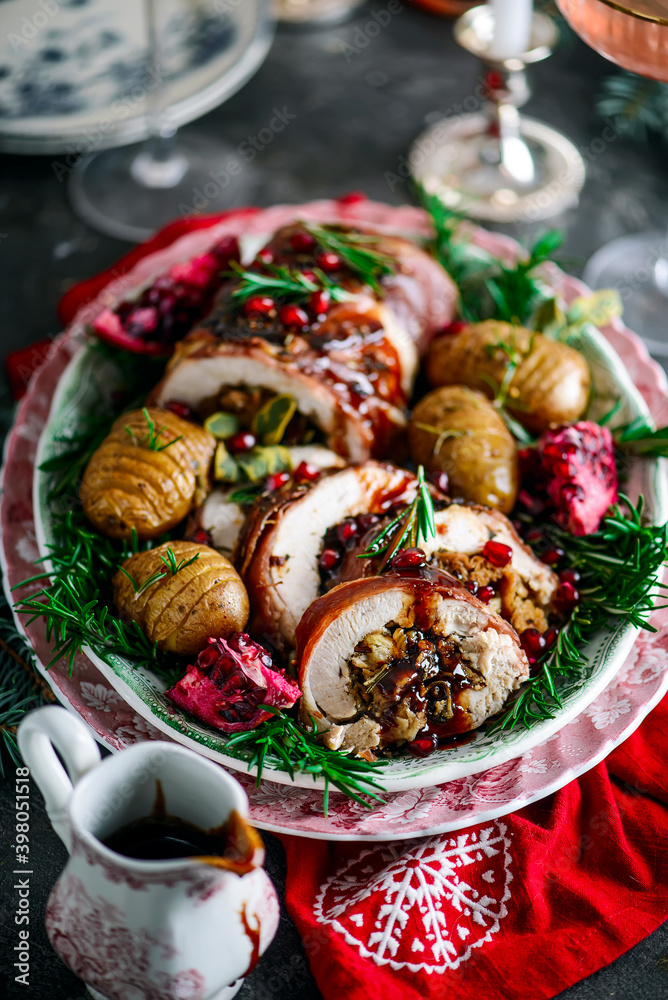 Prosciutto wrapped turkey roulade with pomergranate sauce. .style rustic.
