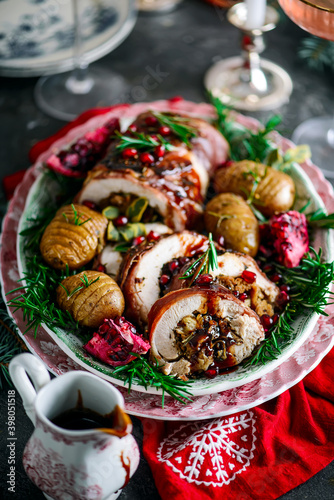Prosciutto wrapped turkey roulade with pomergranate sauce. .style rustic.