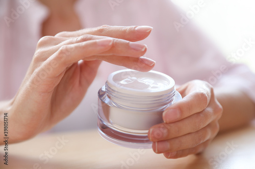 Photos Woman with jar of moisturizing cream, closeup