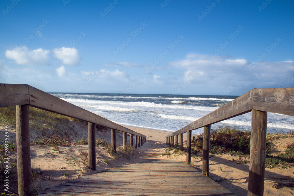 Beach wooden boardwalk leading down to the Atlantic Ocean. Landscape photography at Quiaios Beach in Portugal