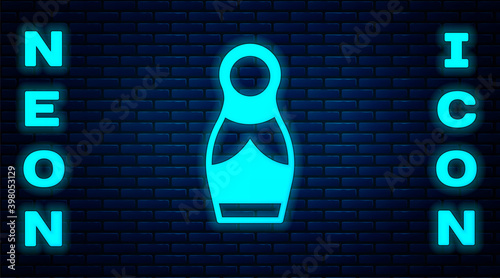 Glowing neon Russian doll matryoshka icon isolated on brick wall background. Vector.
