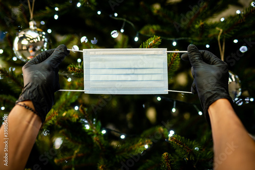 Obraz na płótnie decorating the Christmas tree - medical mask for the Christmas tree - coronavirus pandemic | COVID-19 | Happy Holidays 2020 - Safe Holidays w salonie