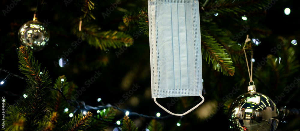 decorating the Christmas tree - medical mask for the Christmas tree - coronavirus pandemic | COVID-19 | Happy Holidays 2020 - Safe Holidays