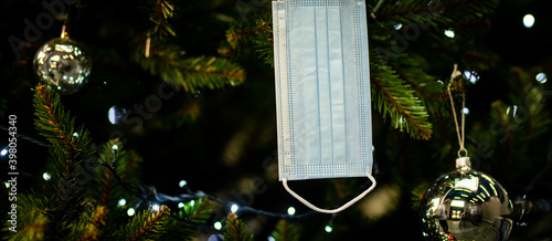 Obraz na płótnie decorating the Christmas tree - medical mask for the Christmas tree - coronavirus pandemic | COVID-19 | Happy Holidays 2020 - Safe Holidays w salonie