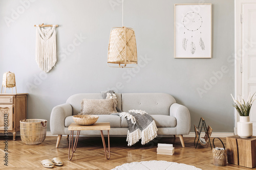 Modern concept in design home interior with grey sofa, coffee table, macrame, plants, carpet and elegant accessories. Stylish and minimalistic home decor. Template. © FollowTheFlow