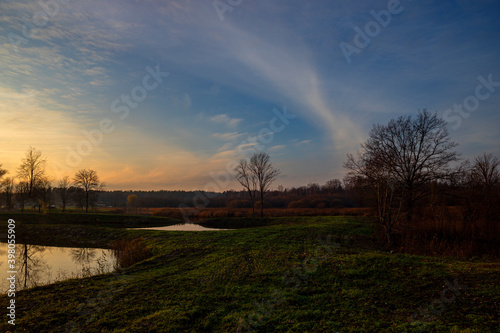 sunset over the meadow with small pond