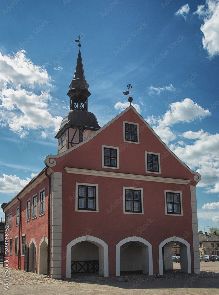 View to the Bauska town hall in historical centre with blue sky and white clouds in background in Bauska, Latvia.