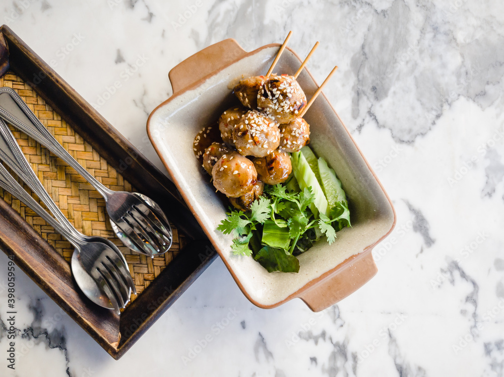 Toasted meatballs topped with spicy sauce Toasted meatballs topped with spicy sauce