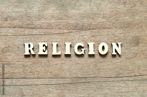 Alphabet letter block in word religion on wood background