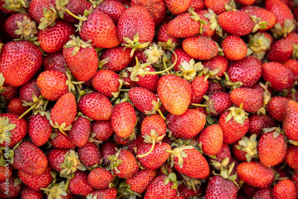 Fresh organic strawberry background. Closeup at the berries on a market. Fresh organic strawberry background. Closeup at the berries on a market.