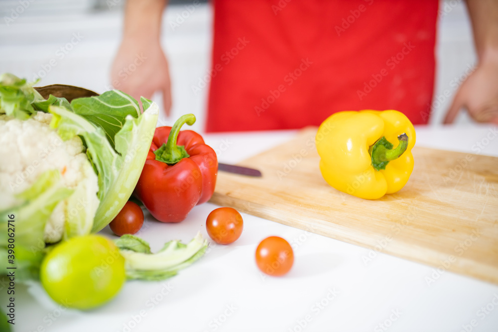 Bag of vegetables above a white table and a cutting board Bag of vegetables above a white table and a cutting board