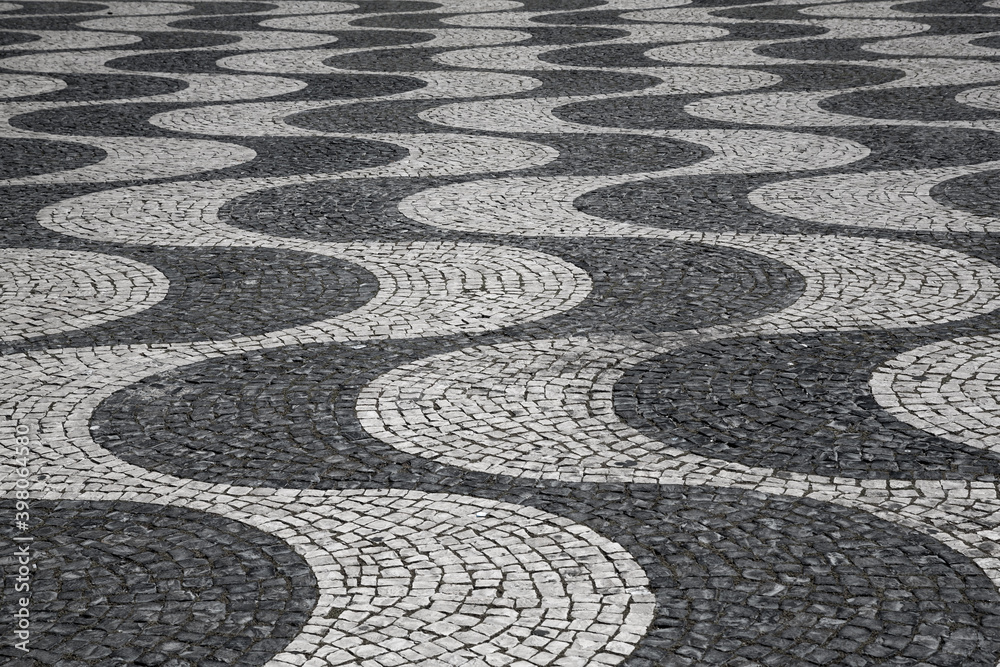 Characteristic wave pattern of cobblestone pavement on Rossio square, Lisbon, Portugal