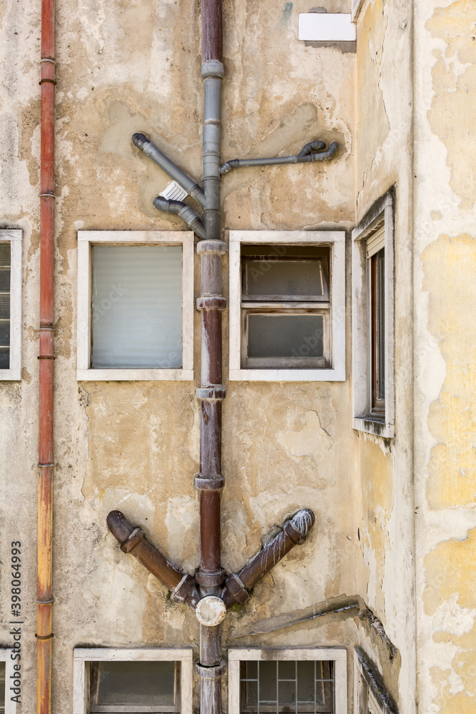Exposed external drainage pipes of old apartment house in Lisbon, Portugal
