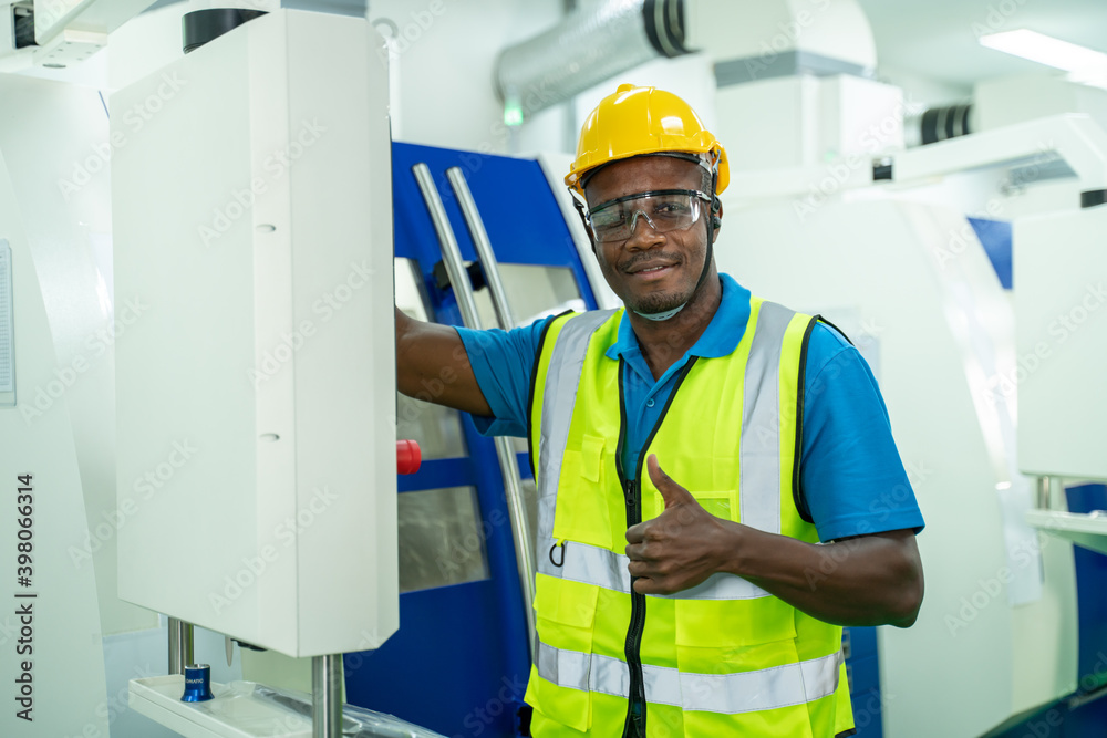 Portrait of african american technician or worker or engineer man stand with confident action in workplace during concern about covid 2019 pandemic in people affect industrial business. Portrait of african american technician or worker or engineer man stand with confident action in workplace during concern about covid 2019 pandemic in people affect industrial business.