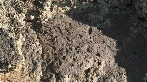 Solidified Igneous Lava Rock.Basalt Spongy structure porous crushed and broken stones frozen gibber reg regs geology geological clinkers scoria magmatic cinder 4K. photo