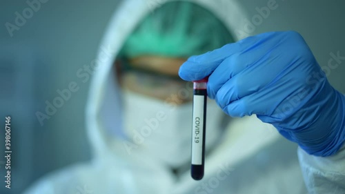 Scientist holding liquid chemical tube in laboratory, Science and technology healthcare concept