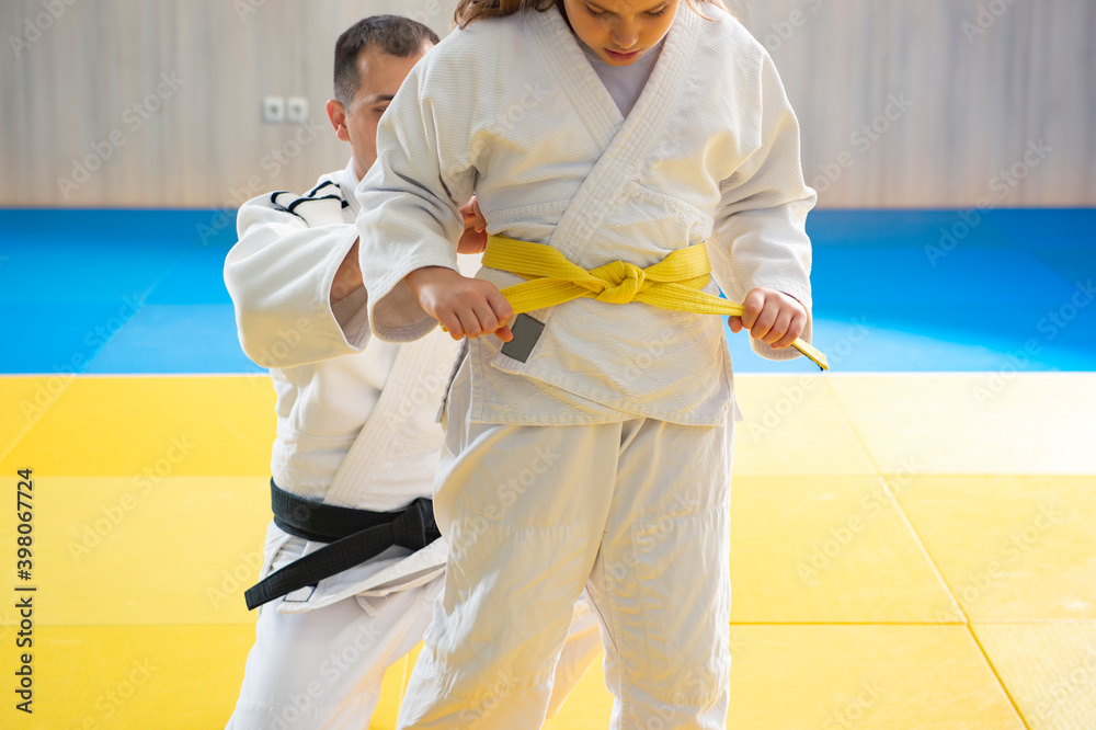 Black belt judoka and young yellow belt judo girl Stock Photo Adobe Stock