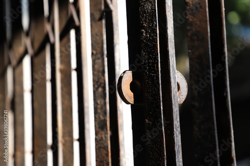 close up of bars in a cage or a  rust on a very old iron collapsible gate close up