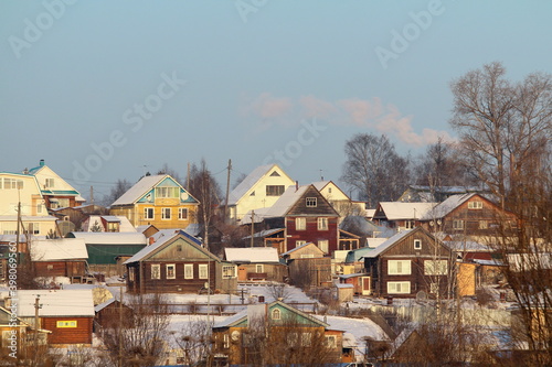 Elegant multi-colored wooden village houses on a clear winter day.